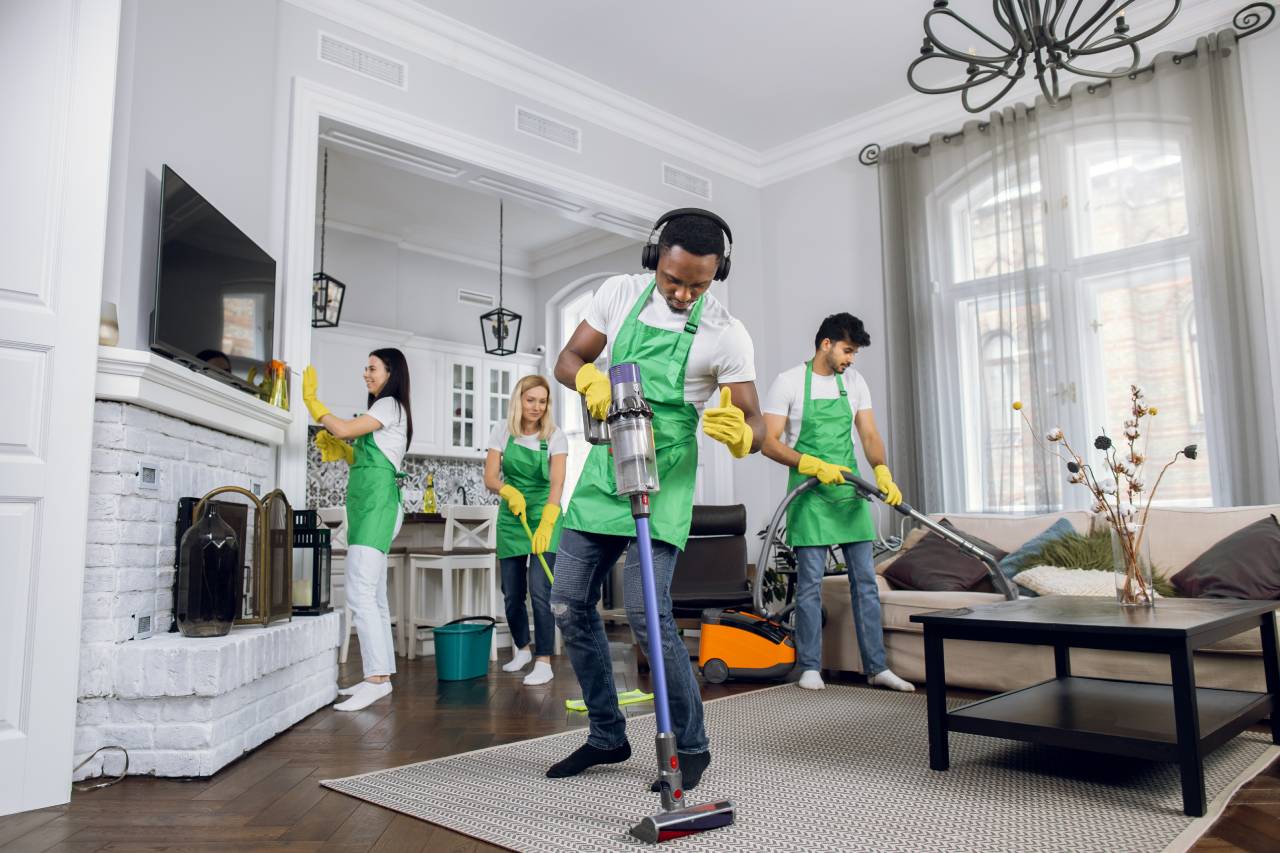 A group of people cleaning the living room