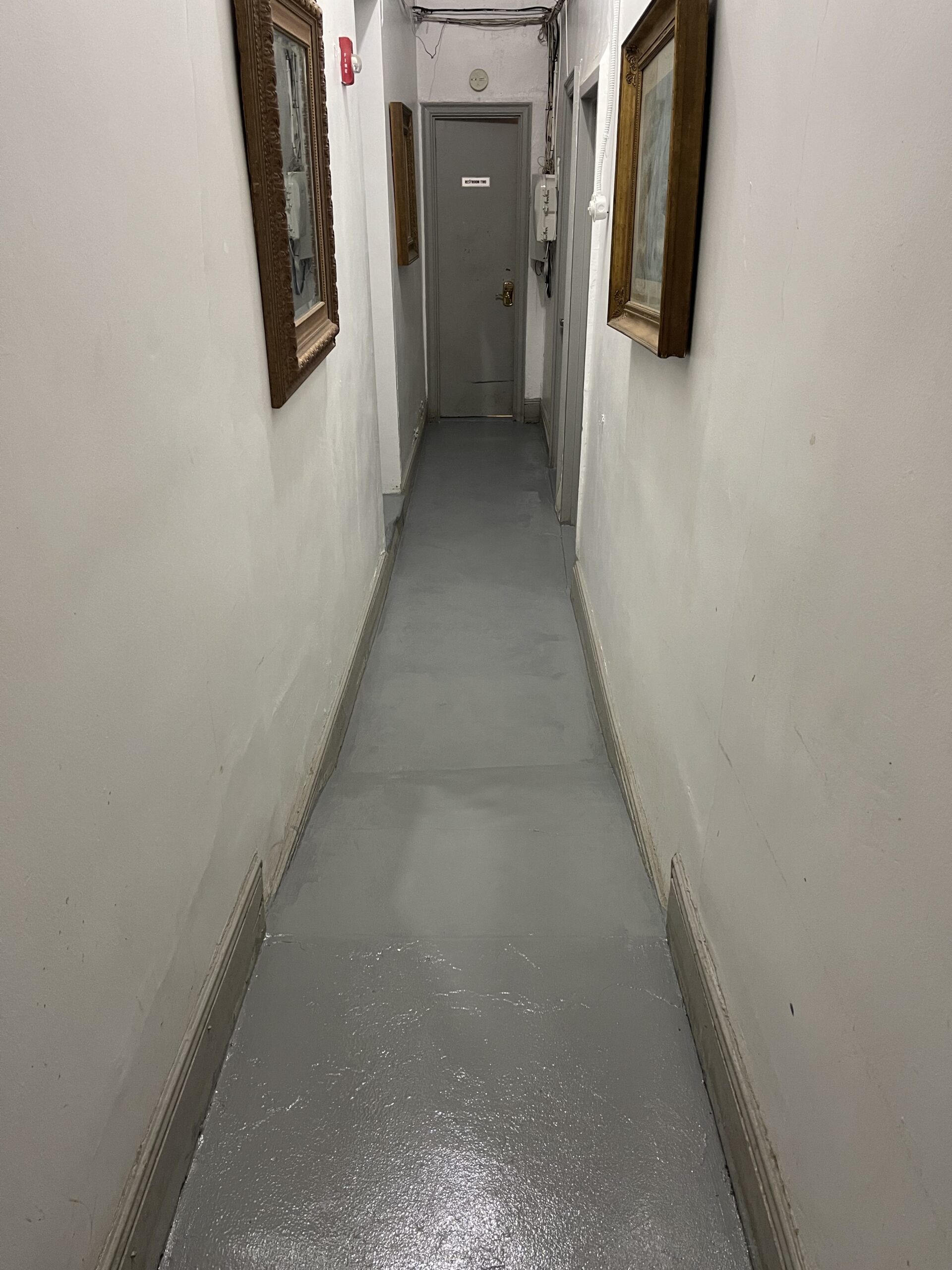 A hallway with two doors and no walls.